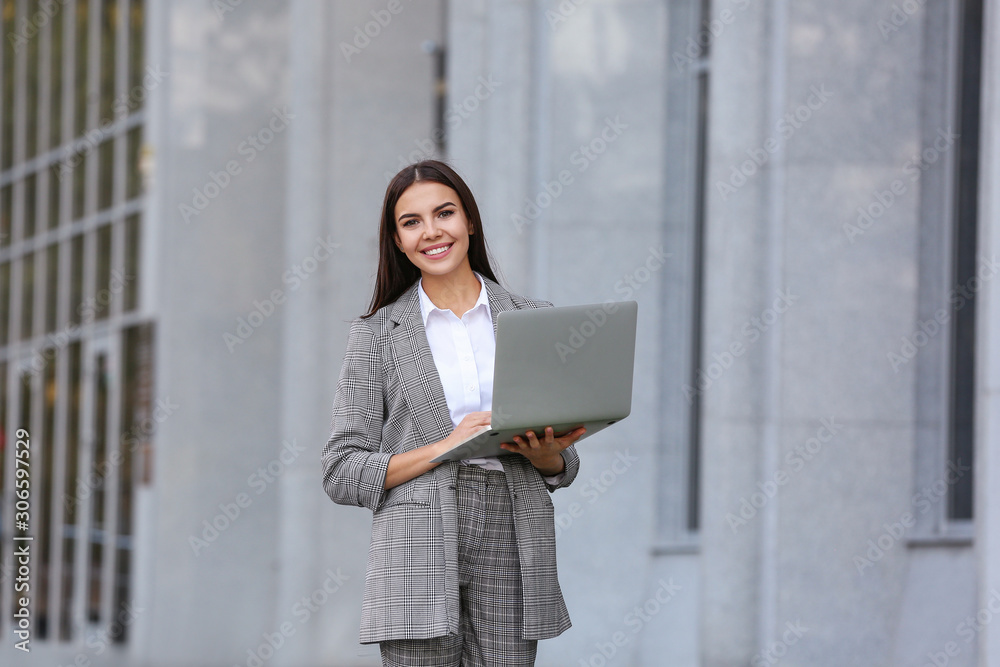 Beautiful young businesswoman with laptop outdoors Beautiful young businesswoman with laptop outdoors