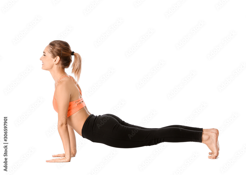 Beautiful young woman practicing yoga on white background