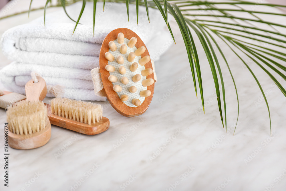 Different brushes and towels on light background Different brushes and towels on light background