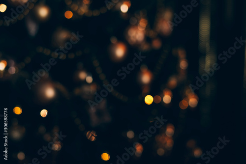 Lights of christmas tree blurred bokeh on dark background.