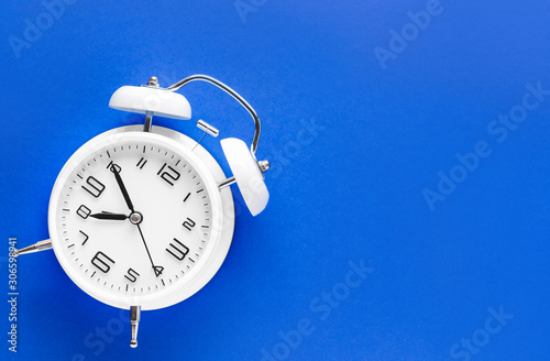 Alarm clock on color background photo