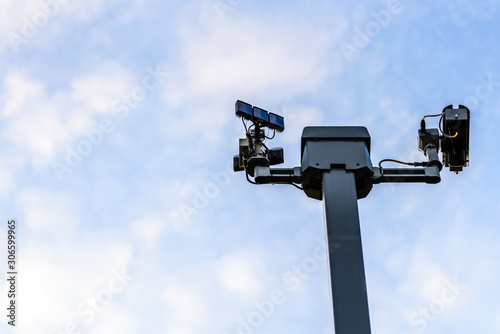 cctv cameras on metal stand over cloudy sky in uk. high angle view
