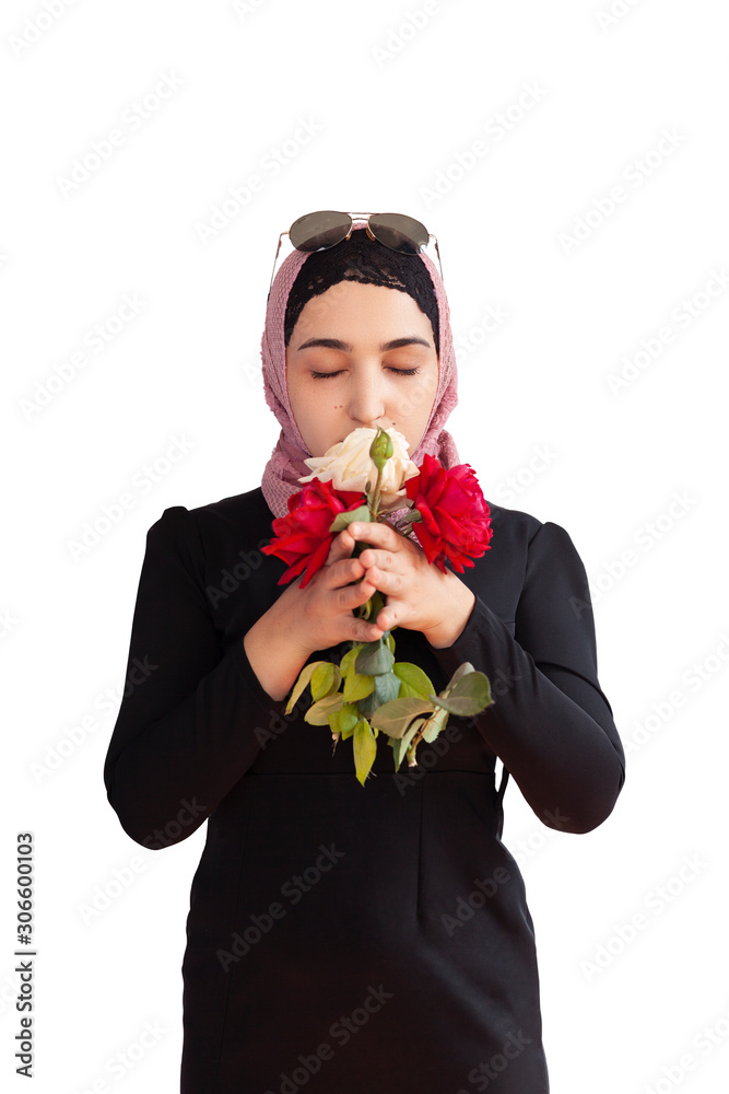 Stylish Muslim woman in traditional Islamic clothing holding flower bouquet. Portrait of beautiful middle-eastern girl in Hijab. Stock photo of Islamic clothing, fashion Stylish Muslim woman in traditional Islamic clothing holding flower bouquet. Portrait of beautiful middle-eastern girl in Hijab. Stock photo of Islamic clothing, fashion
