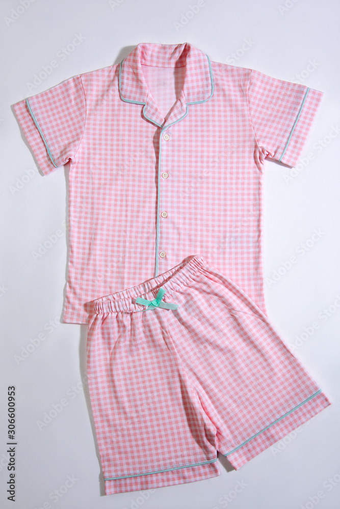 Baby pajamas. Sleeping outfit for baby girl. Pajamas in pink and white colors, square pattern. On white background Baby pajamas. Sleeping outfit for baby girl. Pajamas in pink and white colors, square pattern. On white background
