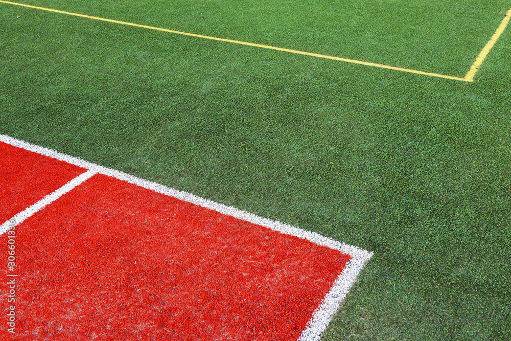 Part of empty used red tennis court playground surface with white lines closeup Part of empty used red tennis court playground surface with white lines closeup