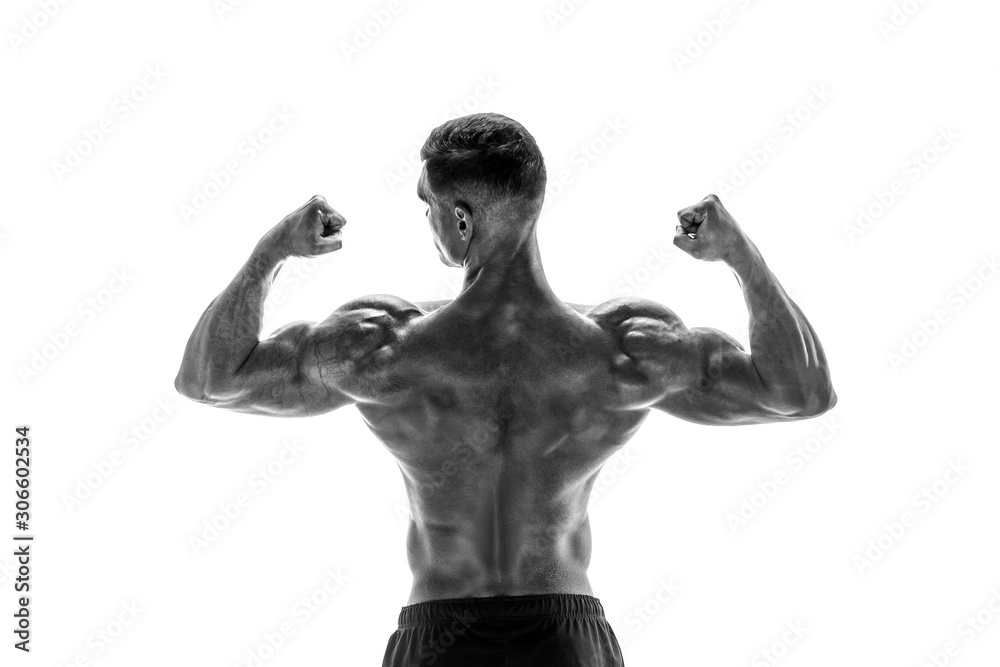 Tattooed Bodybuilder showing his back and biceps muscles isolated on a white background, personal fitness trainer. Strong man flexing his muscles