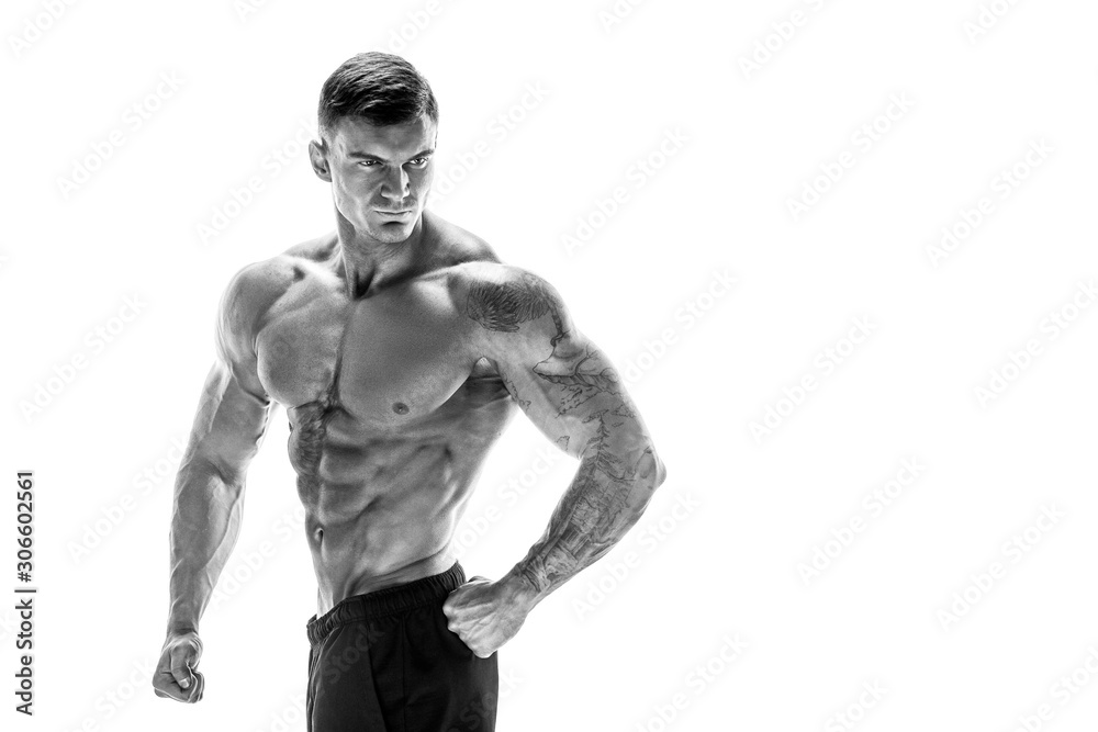 Tattooed muscular super-high level handsome man posing in studio isolated on white background