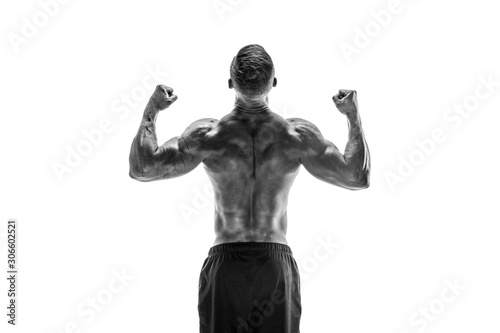 Tattooed Bodybuilder showing his back and biceps muscles isolated on a white background  personal fitness trainer. Strong man flexing his muscles