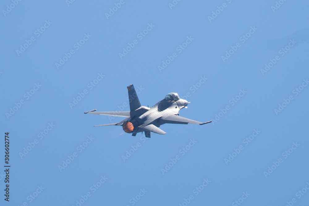 F-16 Fighting Falcon in a high-G maneuver, with afterburner condensation trails at the wing F-16 Fighting Falcon in a high-G maneuver, with afterburner condensation trails at the wing