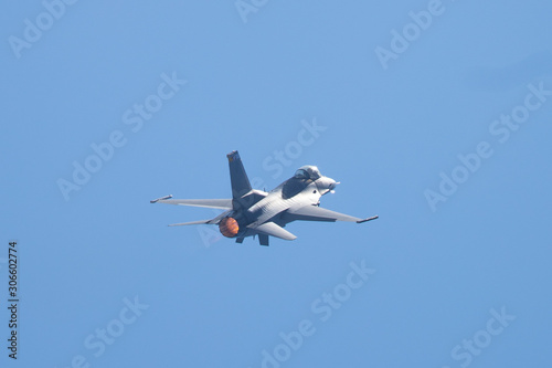 F-16 Fighting Falcon in a high-G maneuver, with afterburner  condensation trails at the wing