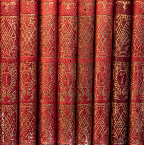 Old books numbered from one till eight in red binding with golden ornaments