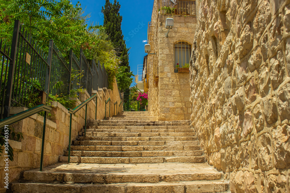 summer time Jerusalem street Israeli land urban landmark view with stairway passage between stone buildings 