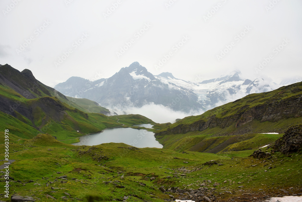 Gorgeous Lake Bachsee (Bachalpsee) in the Bernese Oberland during a misty day, Grindelwald, Switzerland