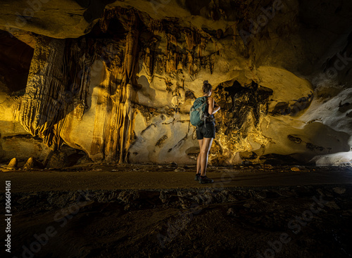 Trung Trung Cave Cat Ba Vietnam Girl Tourist admires beautiful Stalactite formations