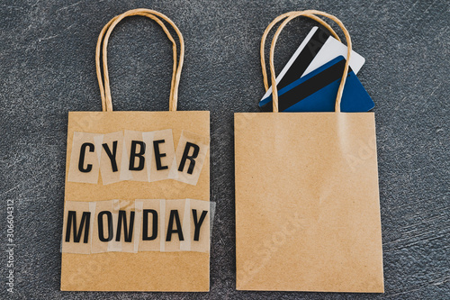 cyber monday shopping bag next to another blank one with payment cards in it