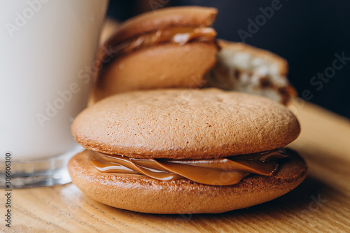 Close up Traditional chocolate and Pumpkin Whoopie pies filled made with vanilla cream cheese in cozy cafe background photo