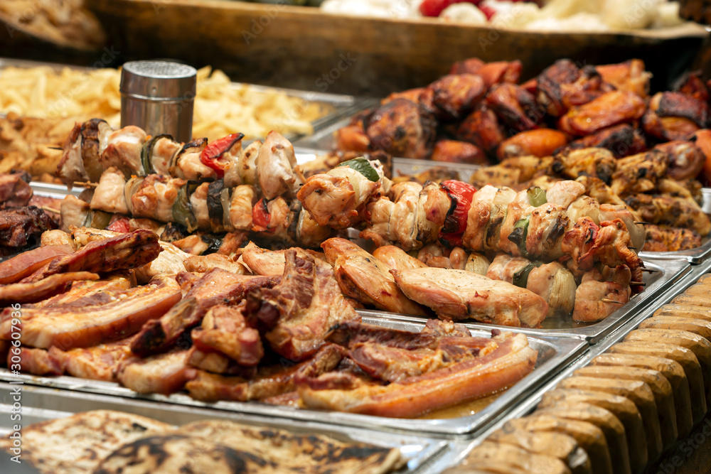 Skewers and other grilled meat dishes for sale at the Christmas market