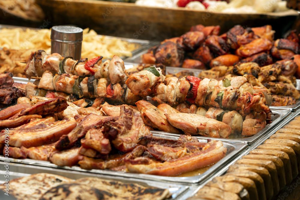 Skewers and other grilled meat dishes for sale at the Christmas market Skewers and other grilled meat dishes for sale at the Christmas market