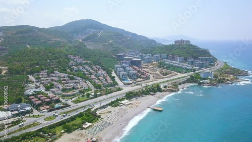 Breathtaking aerial view of the summer city located by the sea, vacation and tourism concept. Art. Landscape of the summer day and many buildings near blue water of the sea. photo
