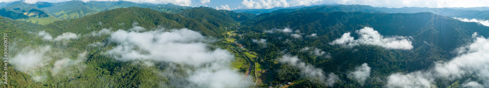 Aerial bird eye view panorama stunning landscape of mountain under sunlight in mist and fog Location at nan province Bo Kluea District Thailand