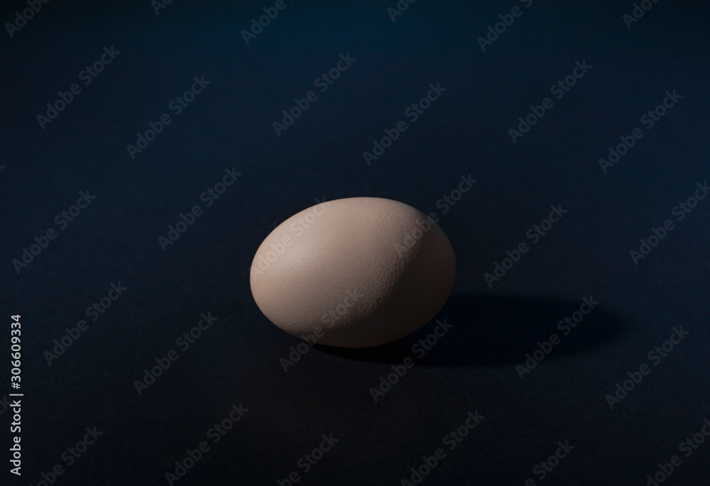 Chicken eggs isolated on dark blue background. Protein source, healthy food Chicken eggs isolated on dark blue background. Protein source, healthy food