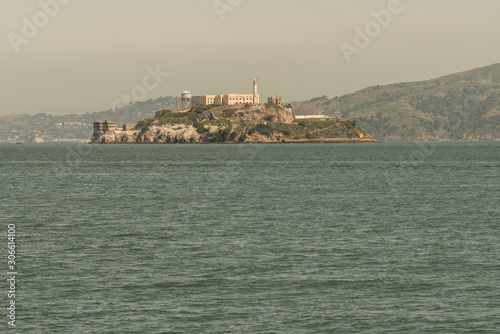 alcatraz prison during a summer day, view of the historic site of alcatraz in san francisco from the city pier during a summer day. united states
