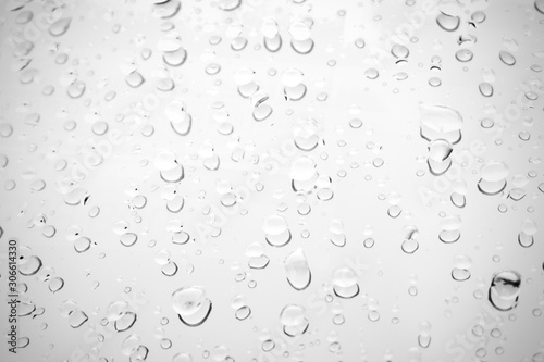 Raindrop water dew drop on glass wet white gray blue background.