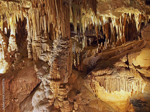 Stalactites and stalagmites inside a natural limestone cavern