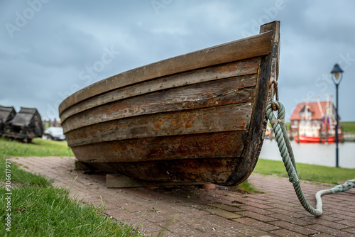 Altes Ruderboot als Ausstellungsstück im Hafen von Fedderwardersiel photo