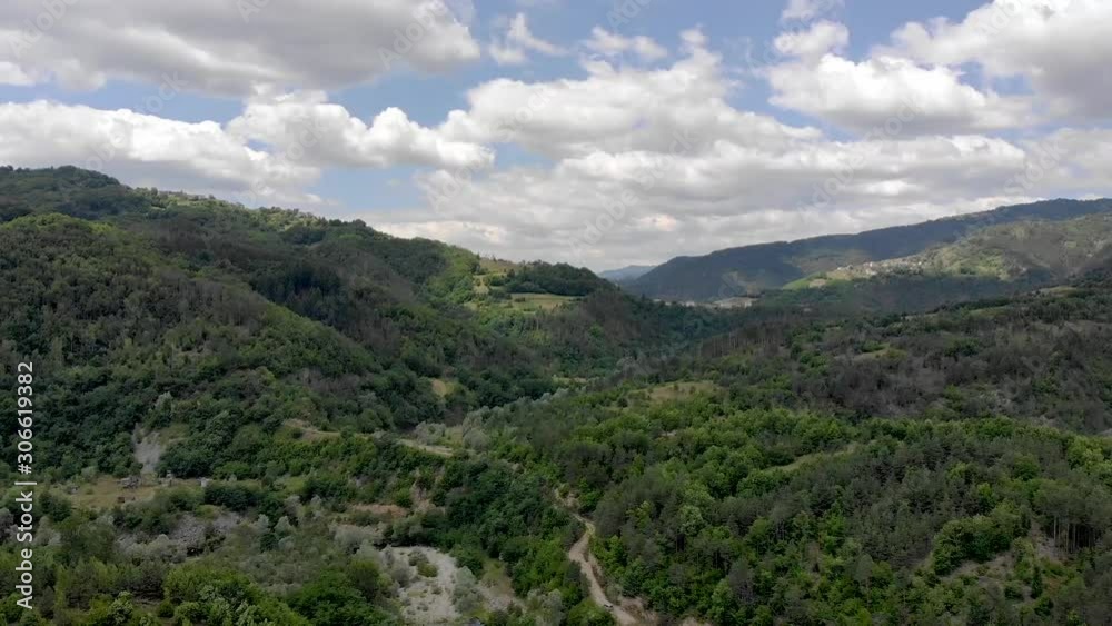 Aerial view of Rhodope mountains while flying down and revealing Arda river with bridge in sight Aerial view of Rhodope mountains while flying down and revealing Arda river with bridge in sight