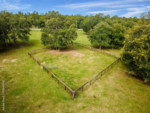 Aerial view of a fenced area in a large field