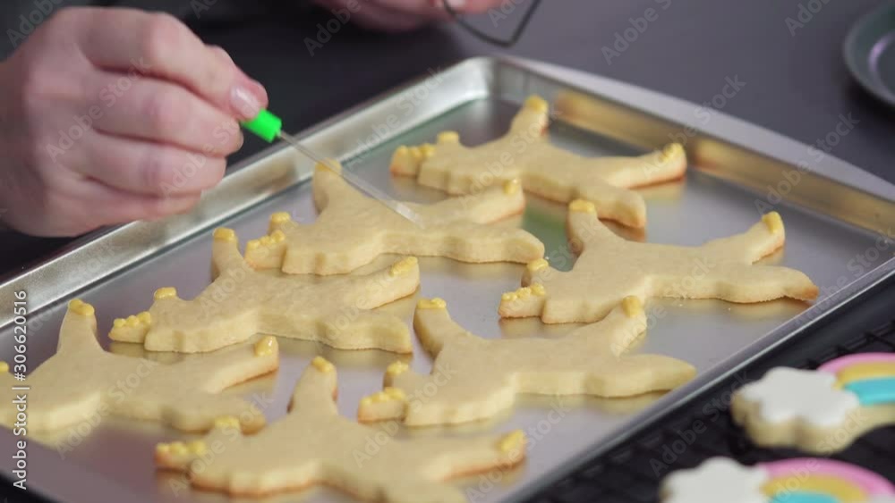 Step by step. Decorating unicorn sugar cookies with royal icing on baking sheet. Step by step. Decorating unicorn sugar cookies with royal icing on baking sheet.