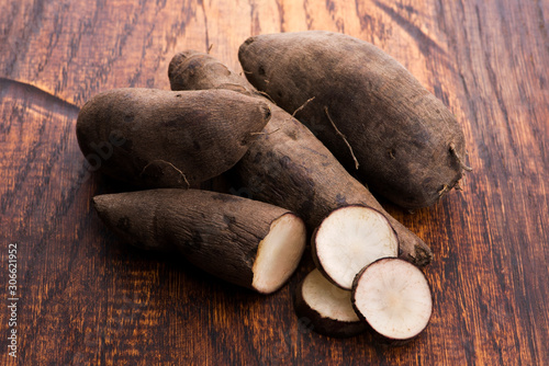 Fresh Yacon roots on wooden background photo