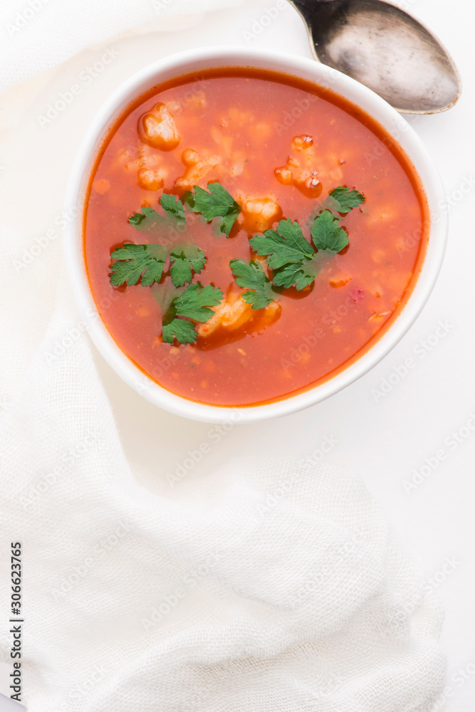 Tomato soup with rice decorated with parsley Tomato soup with rice decorated with parsley