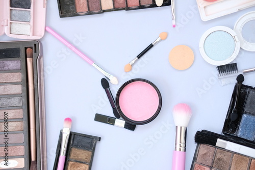 makeup set with brushes and shadows on white background