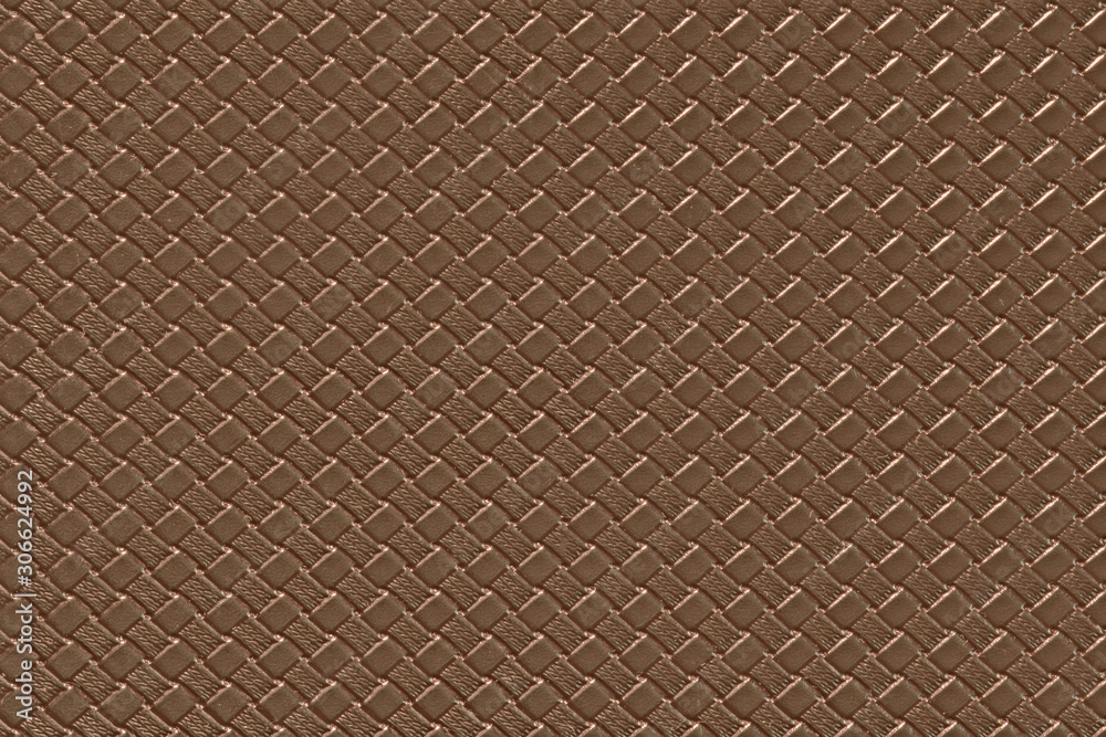 Pale brown leather background with imitation weave texture. Glossy dermantine, artificial leather structure. Pale brown leather background with imitation weave texture. Glossy dermantine, artificial leather structure.