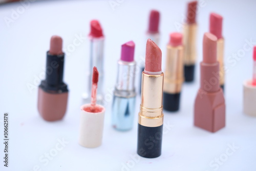 lipstick and nail polish on white background