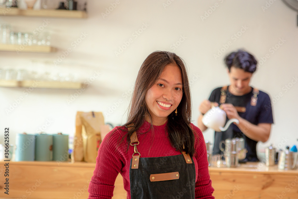 Couple of Asian barista are working in coffee shop. Couple of Asian barista are working in coffee shop.