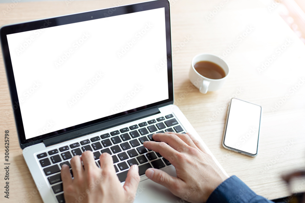 mockup image blank screen computer,cell phone with white background for advertising text,hand man using laptop texting mobile contact business search information on desk in office.marketing and design mockup image blank screen computer,cell phone with white background for advertising text,hand man using laptop texting mobile contact business search information on desk in office.marketing and design
