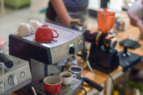 Blurry image top of espresso coffee machine on barista counter