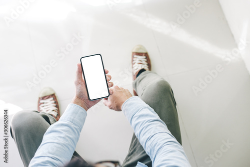 Mockup image blank white screen cell phone.men hand holding texting using mobile  background empty space for advertise text.people contact marketing business and technology  photo