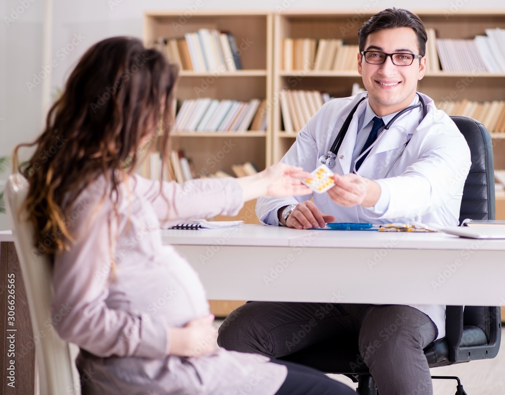 Pregnant woman visiting doctor for consultation