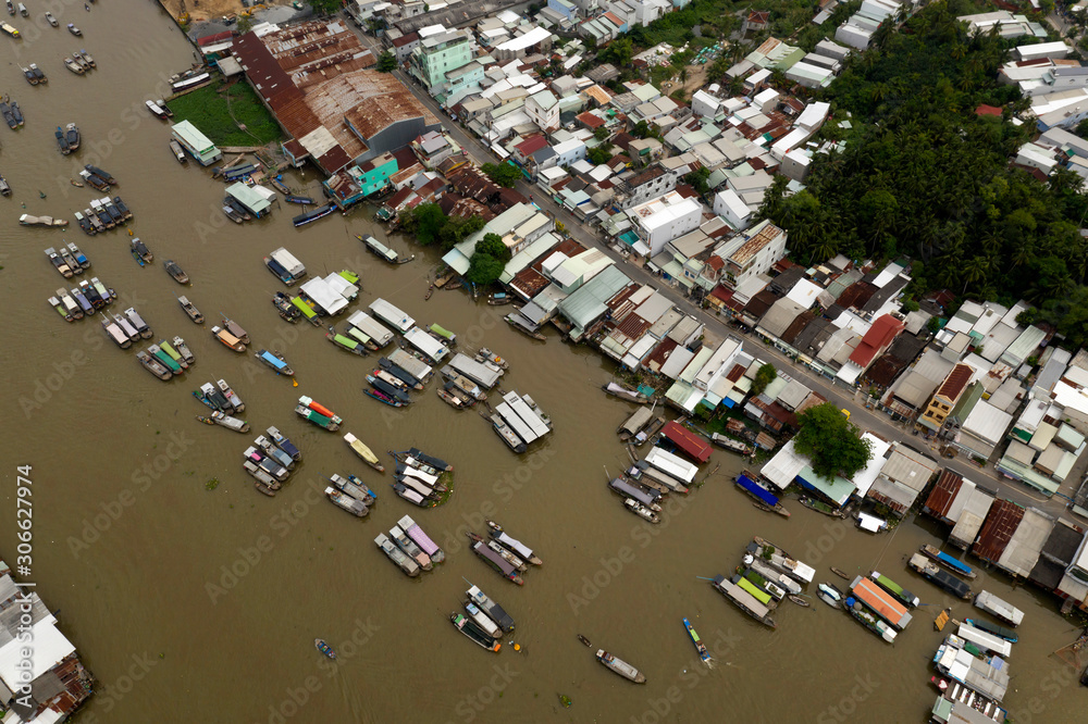 Cai Rang Floating Market on the Mekong River in the morning from aerial perspective featuring the river boats