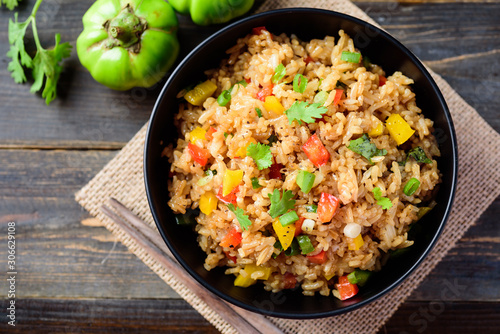 Fried rice with vegetables in a black bowl, Asian food, top view photo