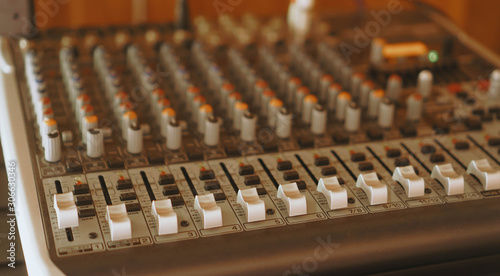 equipment for sound mixer control, audio mixer control panel with buttons and sliders.