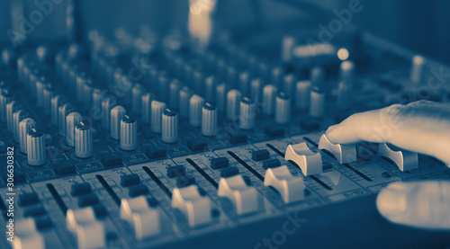 male sound engineer hands working, sound recording studio mixing desk with engineer or music producer