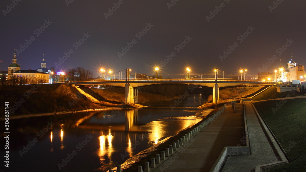 Fototapeta premium Russia, Smolensk famous landmark Uspensky Bridge across Dnieper river, embankment Park and Church, beautiful wide autumn evening view from City Observation deck