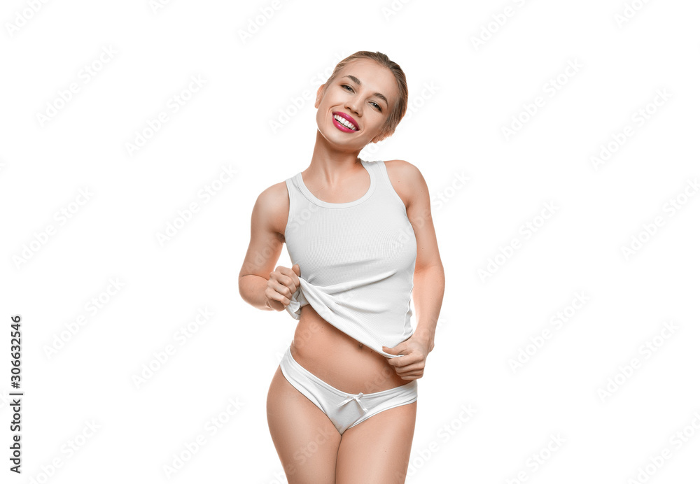 Young smiley woman in white underwear lingerie showing her waist. Isolated on white. Young smiley woman in white underwear lingerie showing her waist. Isolated on white.