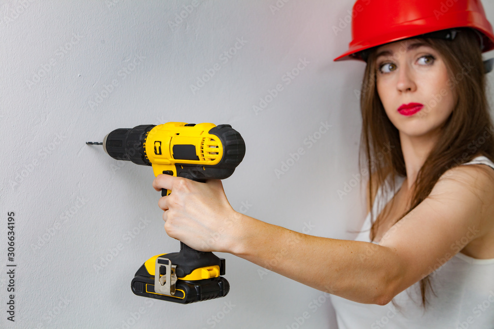 Woman using power driil for work at home Woman using power driil for work at home
