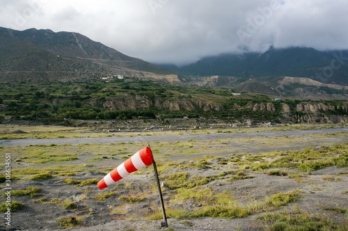 Striped windsock at a local small airfield amid the Himalayan mountains in Jomsom, Nepal. photo